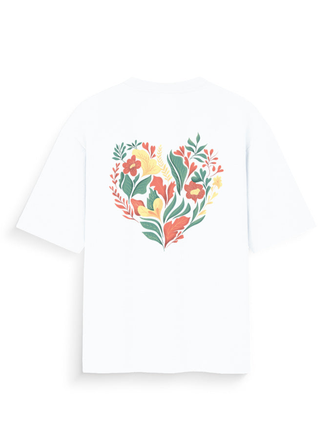 White oversized t-shirt with colorful heart-shaped floral graphic on the back