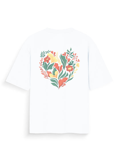White oversized t-shirt with colorful heart-shaped floral graphic on the back