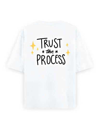 White oversized t-shirt with 'Trust the Process' graphic and yellow star accents on back