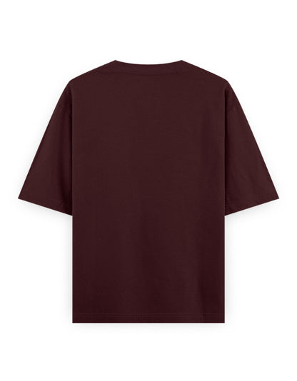 Back view of an oversized plain maroon t-shirt with short sleeves and crew neck