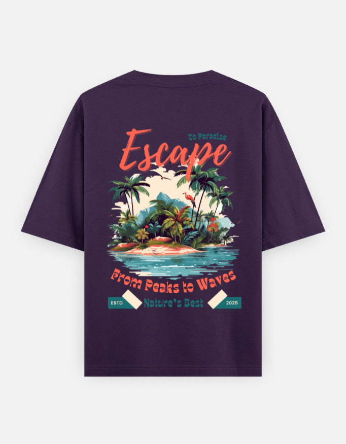 A dark purple short-sleeve t-shirt shown from the back, featuring a colorful graphic print of a tropical island with palm trees, waves, and text reading 'Escape' and 'From Peaks to Waves'.