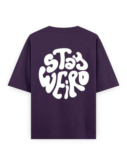 Purple oversized t-shirt with bold white 'Stay Weird' graphic on the back, streetwear fashion