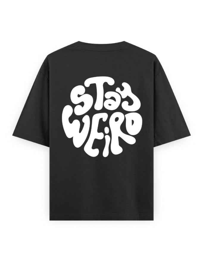 Black oversized streetwear t-shirt with bold 'Stay Weird' graphic on the back