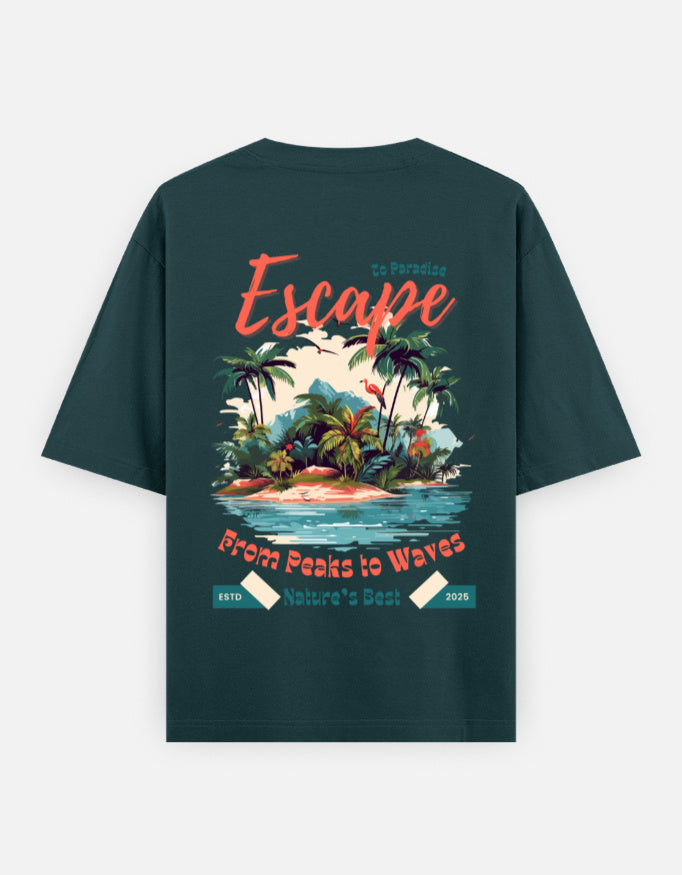 A dark teal green t-shirt shown from the back, featuring a colorful graphic print of a tropical island with palm trees, waves, and retro-style text reading 'Escape from Peaks to Waves' and 'Nature's Best 2026'.