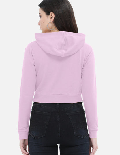 Back view of woman in pastel pink cropped hoodie and black high-waisted jeans