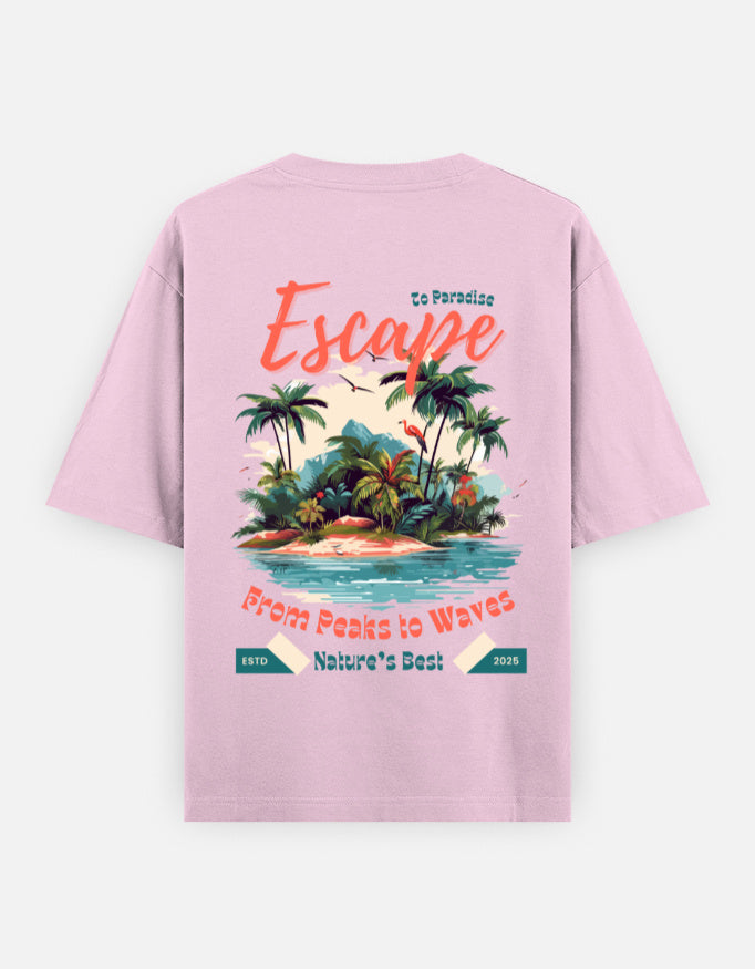 A light pink short-sleeve t-shirt shown from the back, featuring a colorful graphic print of a tropical island with palm trees and text that reads 'Escape' and 'From Peaks to Waves'.
