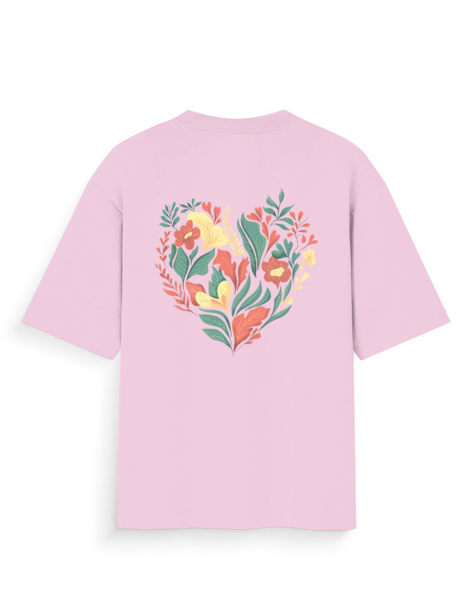 Pink oversized t-shirt with colorful floral heart graphic on back, streetwear style