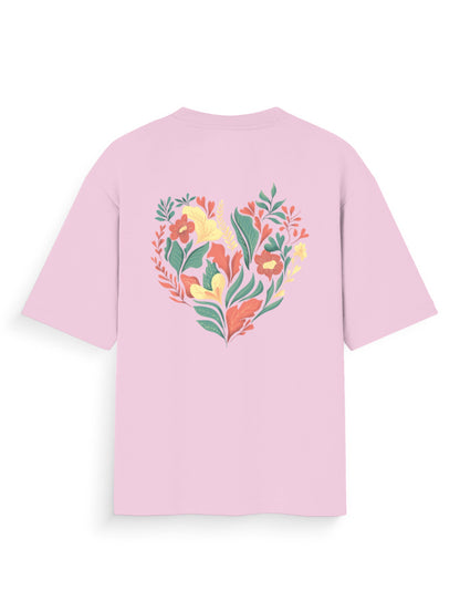 Pink oversized t-shirt with colorful floral heart graphic on back, streetwear style