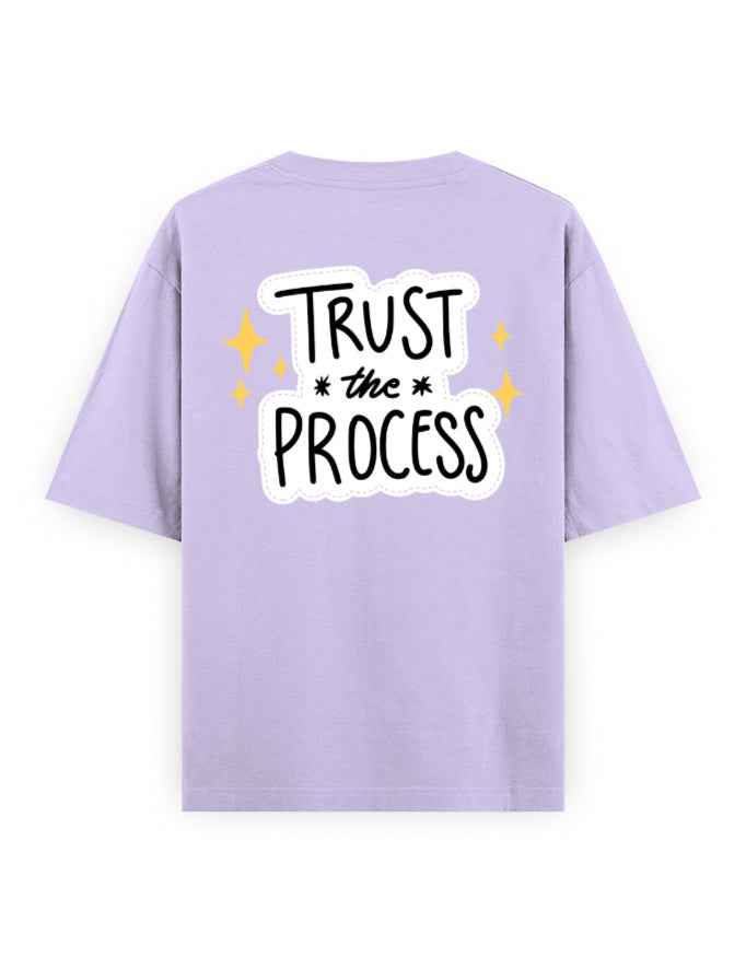 Lavender oversized t-shirt with 'Trust the Process' graphic and yellow stars on the back