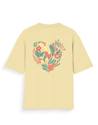 Oversized beige t-shirt with colorful floral heart graphic on the back