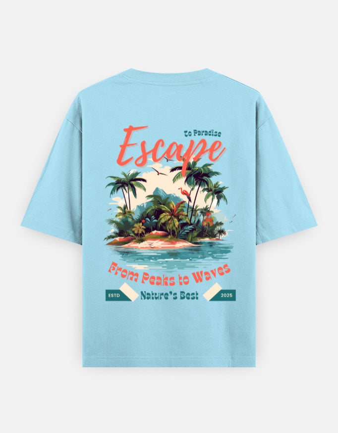 A light blue short-sleeve t-shirt shown from the back, featuring a colorful graphic print of a tropical island with palm trees and text that reads 'Escape', 'From Peaks to Waves', and 'Nature's Best'.