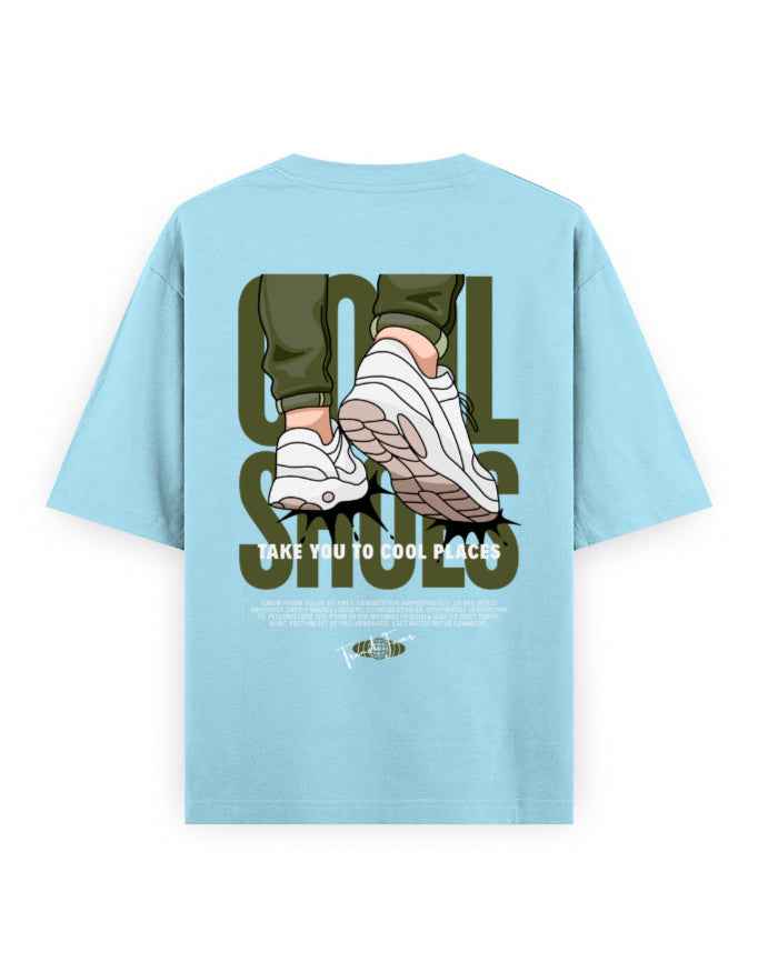 Light blue oversized t-shirt with graphic print of sneakers, bold text, and streetwear style.