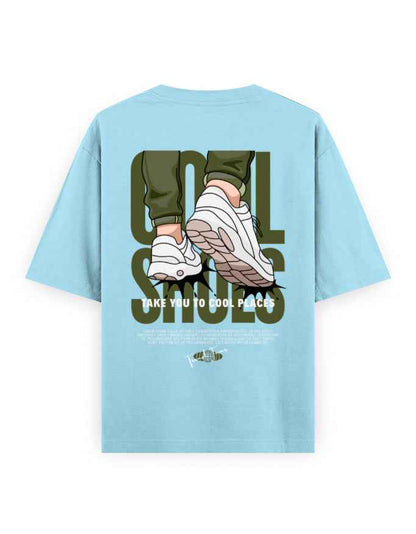 Light blue oversized t-shirt with graphic print of sneakers, bold text, and streetwear style.