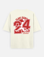 An off-white short-sleeve t-shirt with a large red and white graphic on the back featuring the text 'SLAM DUNK', the number '24', and a silhouette of a basketball player jumping, with 'REST ABOVE THE KIM, RISE THE DAY.' printed below.