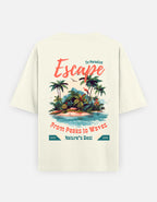 An off-white short-sleeve t-shirt with a large, colorful graphic print on the back. The graphic features a tropical island illustration with palm trees, blue water, and coral text reading 'Escape', 'To Paradise', 'From Peaks to Waves', and 'Nature's Best'. By Trend Fever