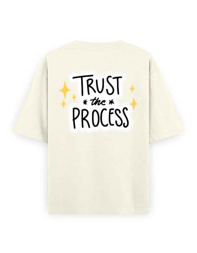 Oversized beige streetwear t-shirt with 'Trust the Process' text on the back, casual style