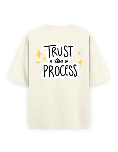 Oversized beige streetwear t-shirt with 'Trust the Process' text on the back, casual style