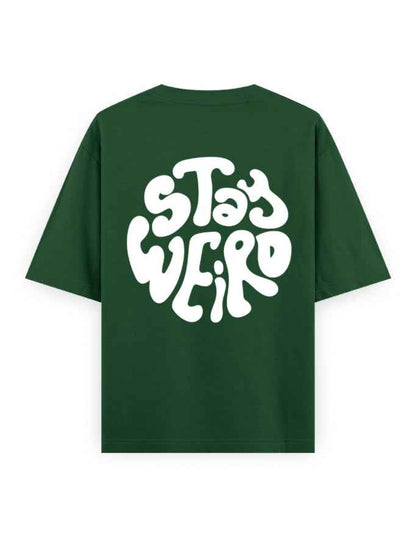 Oversized green t-shirt with bold white 'Stay Weird' graphic on the back, streetwear fashion