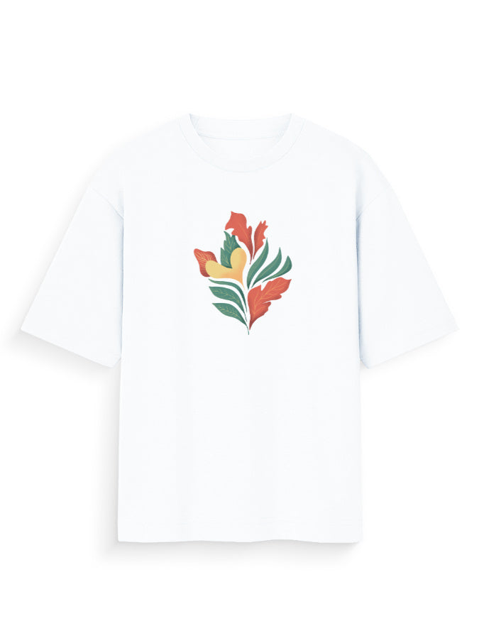 White oversized t-shirt with abstract botanical print in orange, green, and yellow.