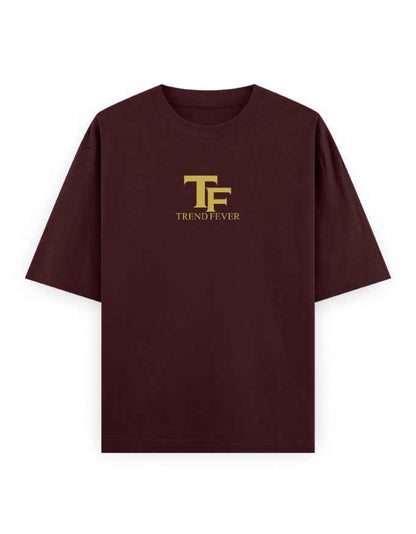 Oversized dark brown t-shirt with bold yellow TF logo and 'TREND FEVER' text on chest