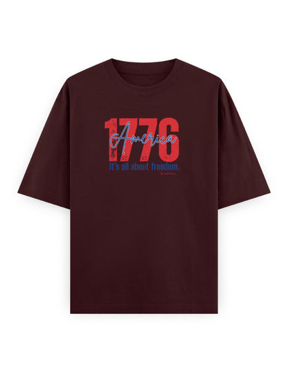 Oversized maroon streetwear t-shirt with '1776 America' bold graphic and freedom slogan.