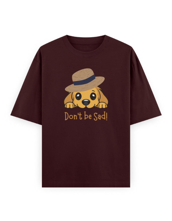 Oversized maroon t-shirt with cute dog in hat and 'Don't be Sad!' text graphic.