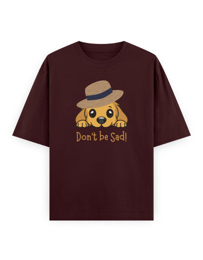 Oversized maroon t-shirt with cute dog in hat and 'Don't be Sad!' text graphic.