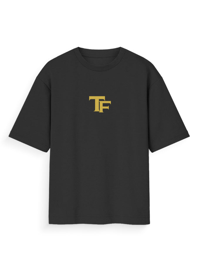 Black oversized streetwear t-shirt with yellow TF logo on chest, modern unisex fashion