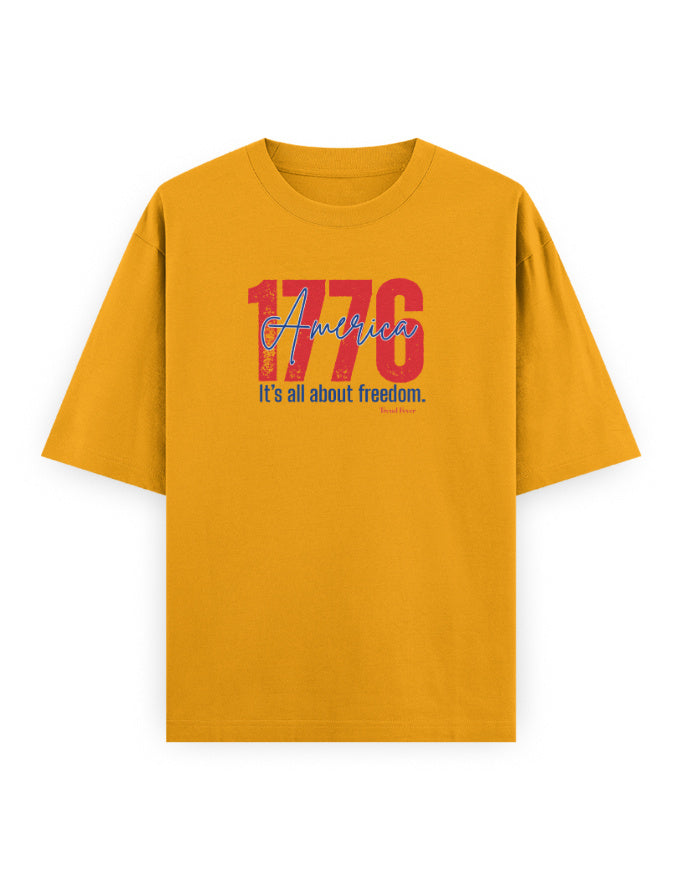 Yellow oversized t-shirt with '1776 America It’s all about freedom' graphic text print
