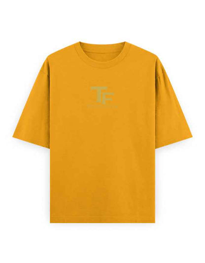 Oversized mustard yellow t-shirt with subtle TF logo on front, streetwear fashion