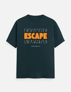 A dark teal short-sleeve t-shirt with a graphic on the chest reading 'ESCAPE ESCAPE ESCAPE' in orange and white, with 'FROM REALITY' printed below, displayed against a light gray background.