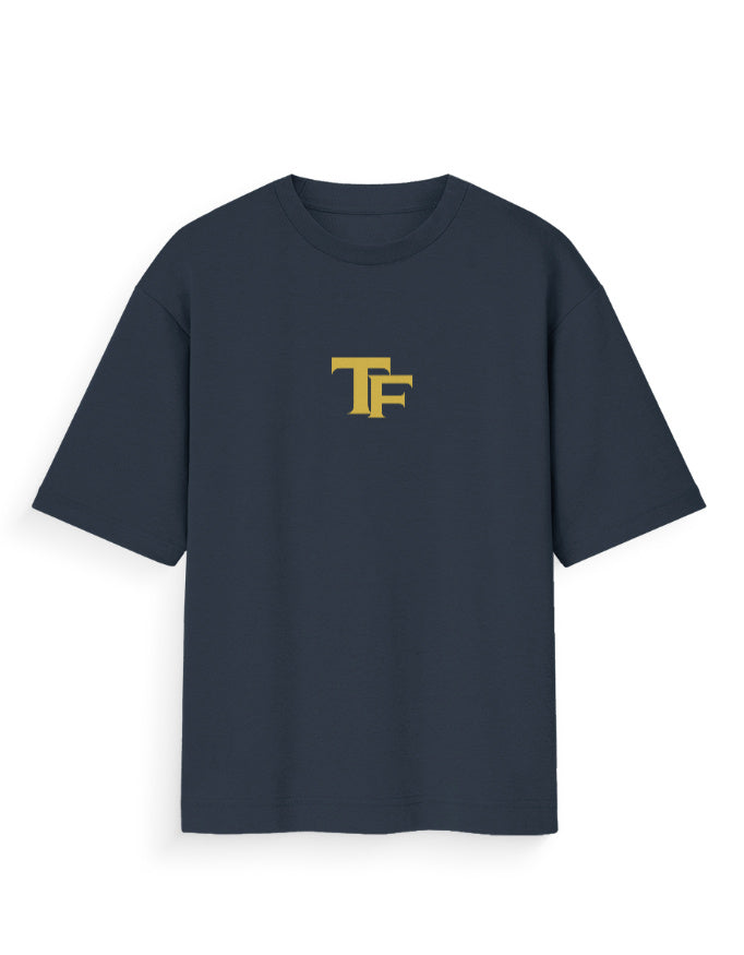 Oversized black t-shirt with yellow TF logo on front, modern streetwear style
