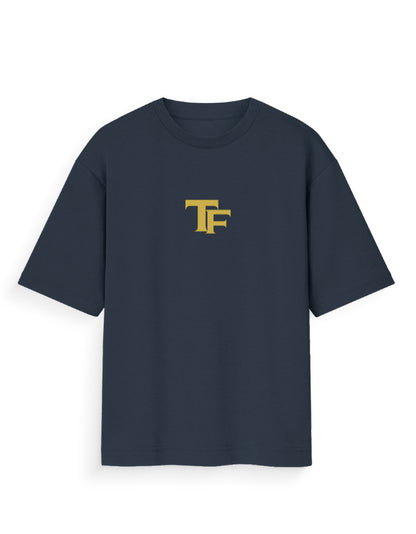 Oversized black t-shirt with yellow TF logo on front, modern streetwear style