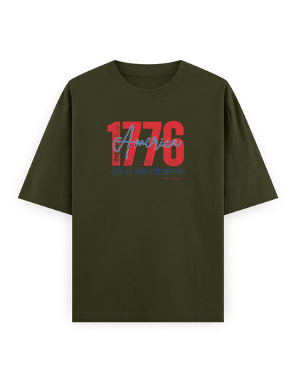 Olive green oversized t-shirt with '1776 America It's all about freedom.' graphic print.