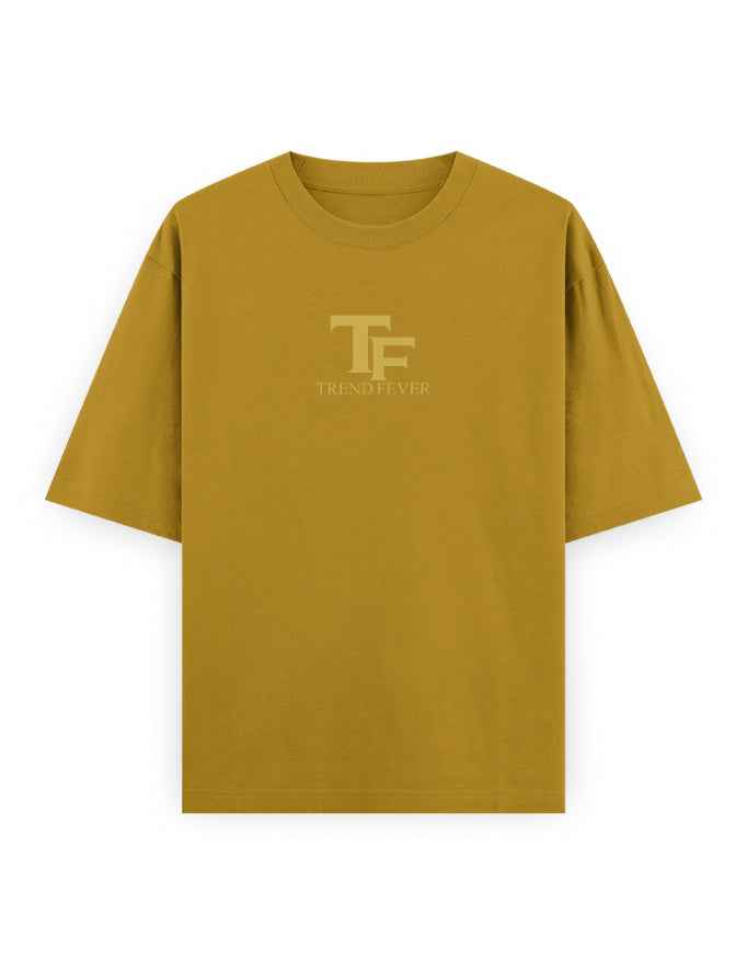 Oversized mustard yellow streetwear t-shirt with subtle TF logo on front