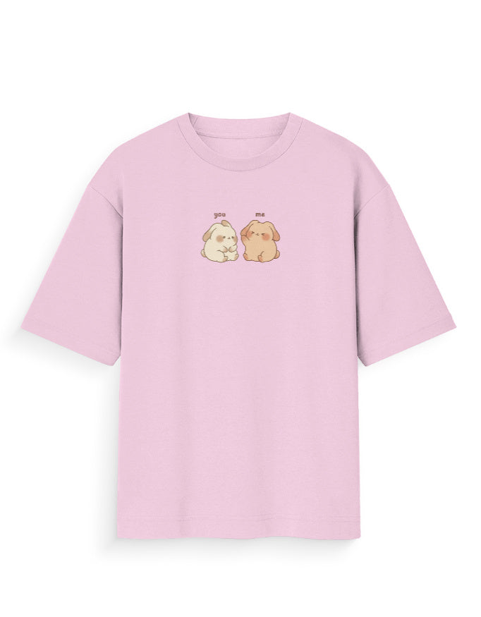 Light pink oversized T-shirt with cute cartoon dog graphic and 'you me' text on chest