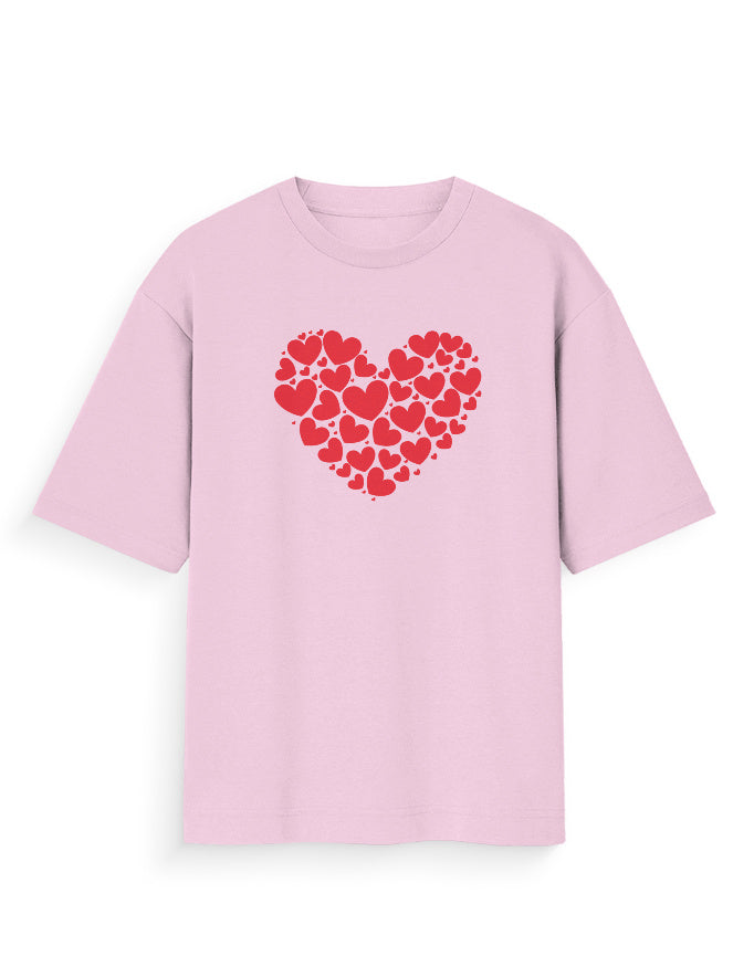 Light pink oversized t-shirt with red heart pattern graphic, streetwear style