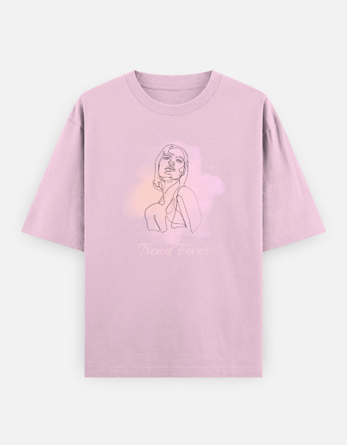 A Baby Pink short-sleeve t-shirt with a graphic print of a woman in a pink and white cloud with the text 'Trend Fever' on the front, displayed against a light gray background.