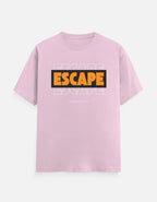 A TREND FEVER light pink short-sleeve t-shirt with a graphic on the chest. The graphic features the word 'ESCAPE' in bold orange letters inside a black rectangular box, with a faded white 'ESCAPE' text pattern in the background and 'FUCK REALITY' printed in small white text below.