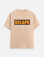 A light beige crewneck t-shirt featuring a graphic on the chest with the word 'ESCAPE' in bold orange letters inside a black rectangle, with faint gray 'ESCAPE' text behind it and 'FUCK EVERY' in small gray text below.