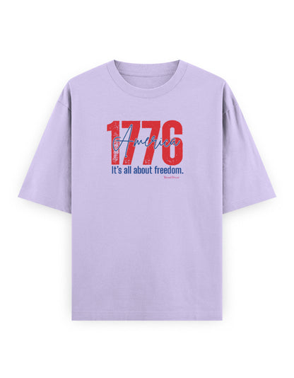 Oversized lavender t-shirt with bold '1776 America' and 'It's all about freedom' graphic print