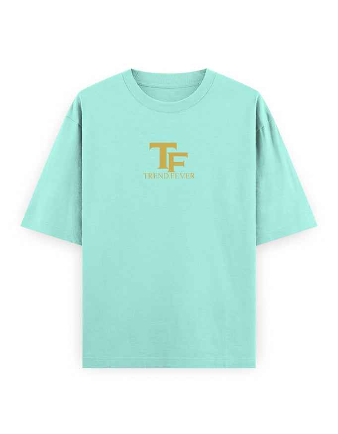 Mint green oversized t-shirt with gold TF Trend Fever logo on chest, streetwear style