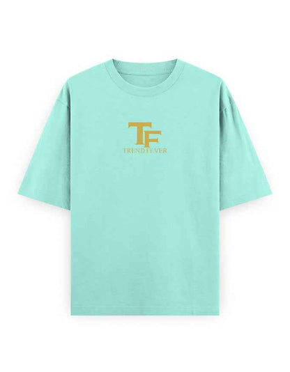 Mint green oversized t-shirt with gold TF Trend Fever logo on chest, streetwear style