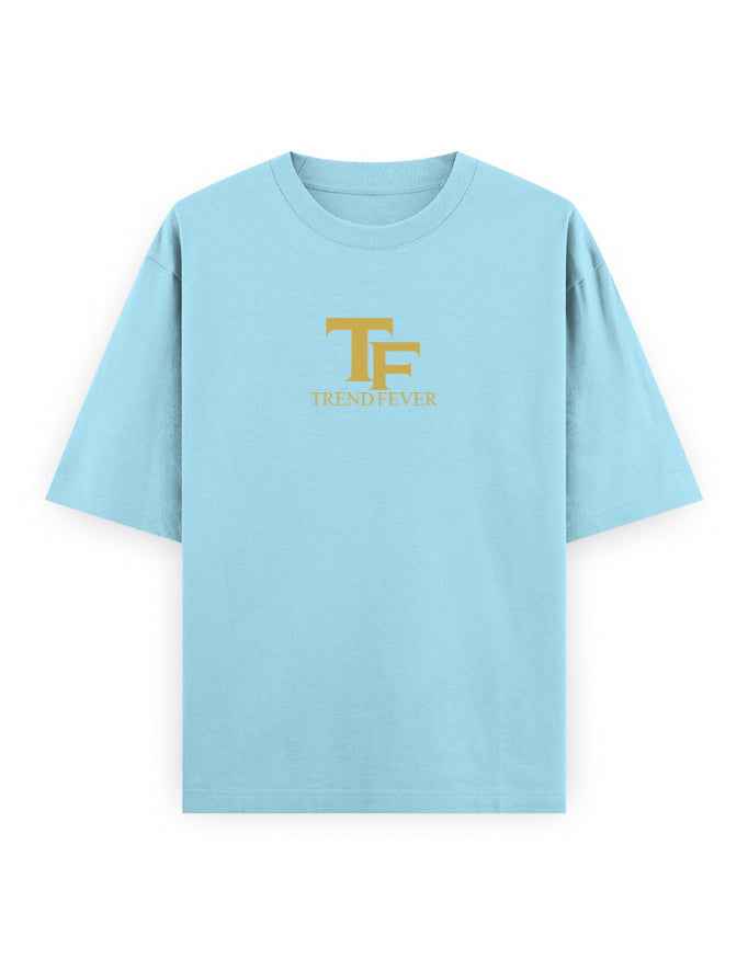 Light blue oversized t-shirt with gold TF TrendFever logo on front, streetwear style