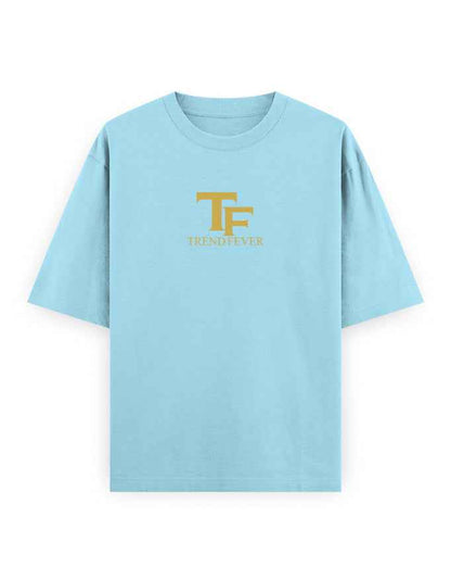 Light blue oversized t-shirt with gold TF TrendFever logo on front, streetwear style