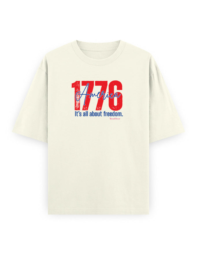 Oversized off-white t-shirt with red and blue '1776 America' graphic and 'It's all about freedom.' text.