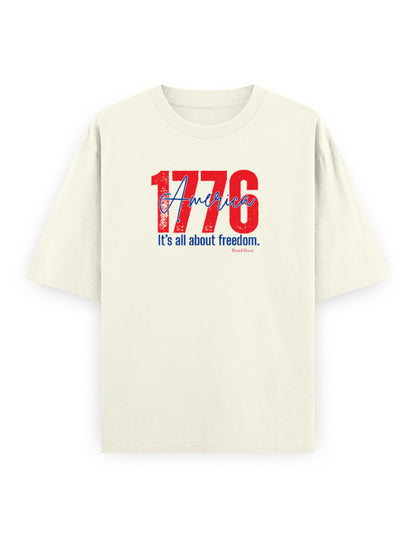 Oversized off-white t-shirt with red and blue '1776 America' graphic and 'It's all about freedom.' text.