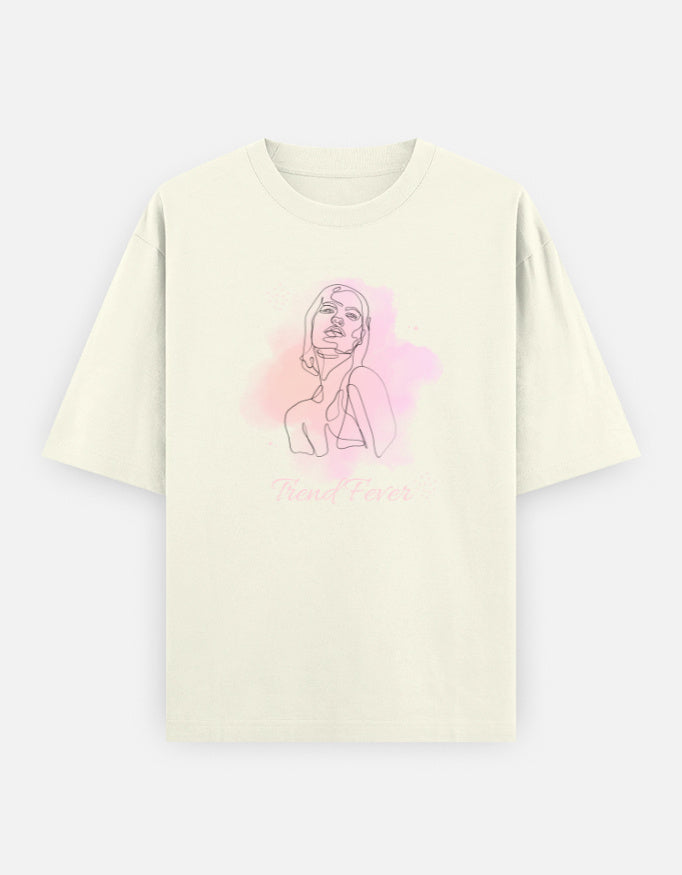An off-white short-sleeve T-shirt with a pink watercolor graphic of a woman's line art illustration and the text 'Trend Fever' printed on the front, displayed against a light gray background.