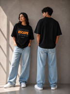 A man and a woman modeling matching TREND FEVER black graphic t-shirts and light-wash wide-leg jeans against a textured gray concrete wall.