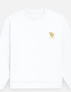 A white crewneck sweatshirt with a small gold 'TF' logo printed on the left chest, shown against a light gray background.